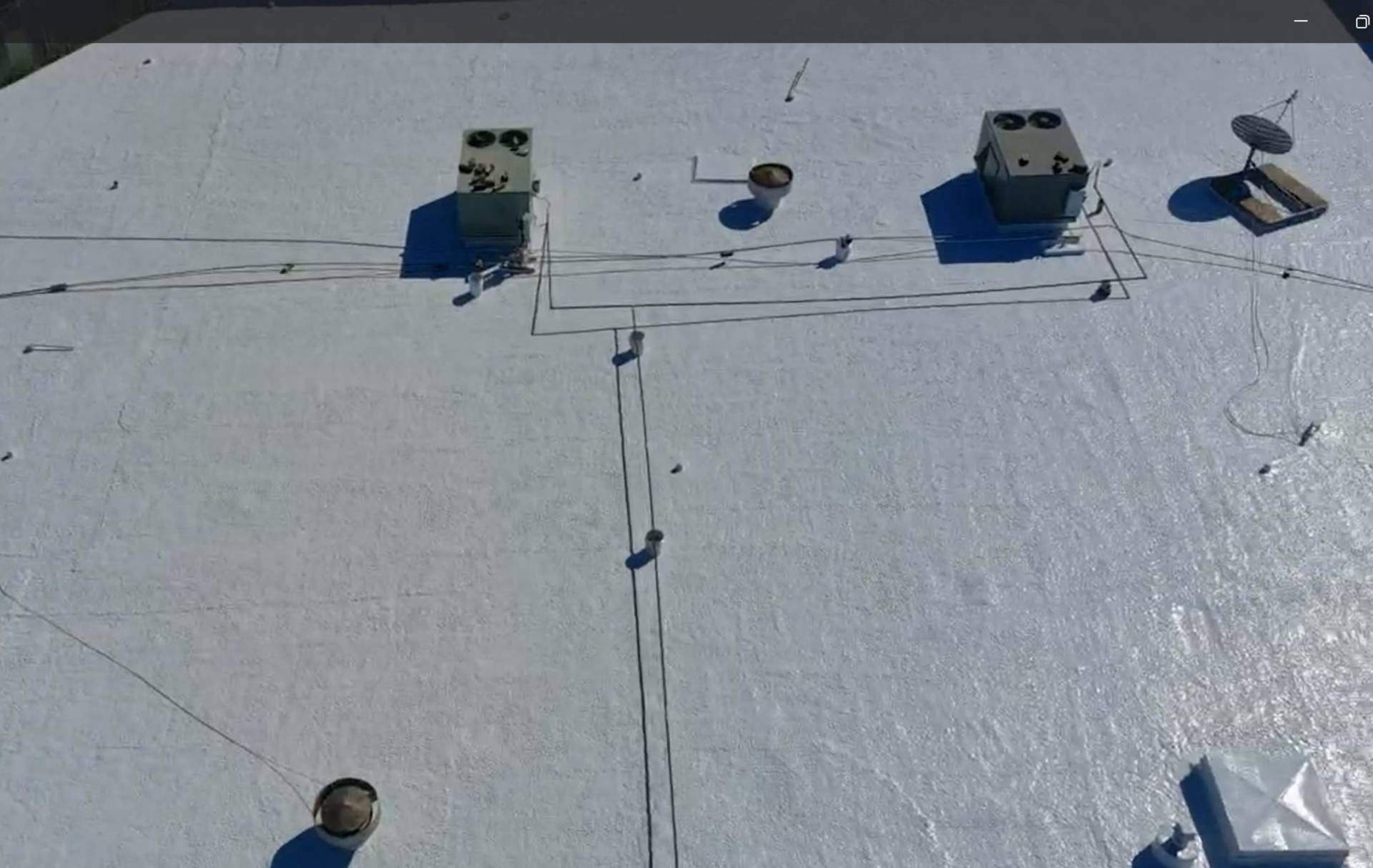 Finished white silicone coating on the commercial flat roof