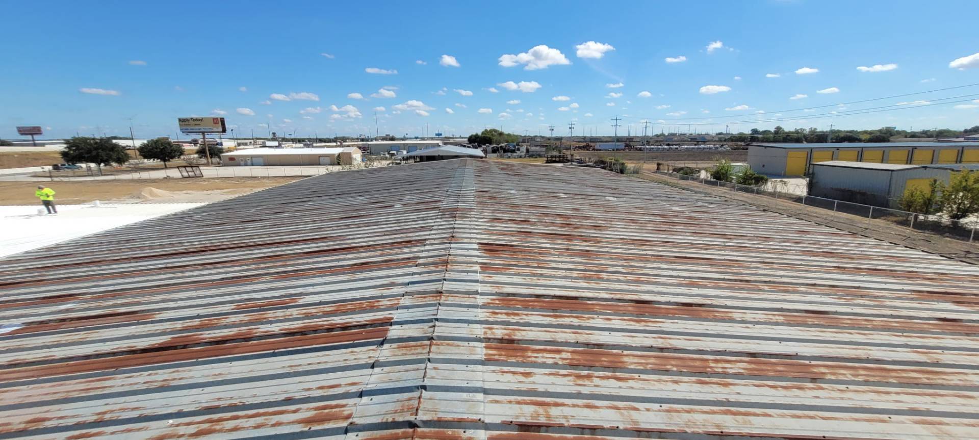 Rust-streaked metal roof before the three-layer acrylic coating