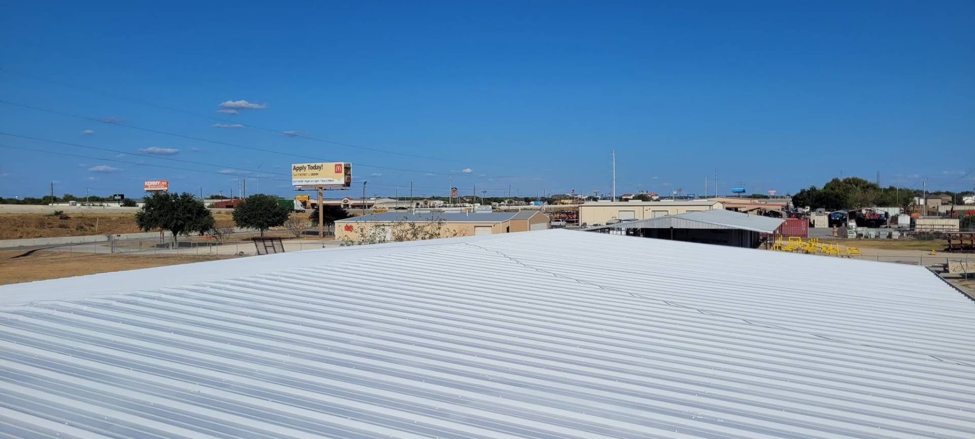 Finished white metal roof with a three-layer acrylic coating system